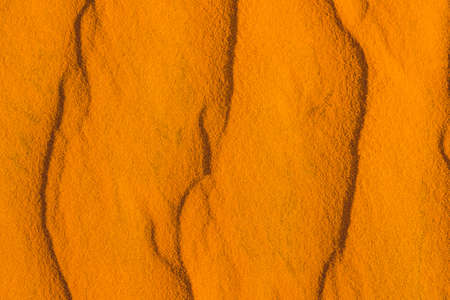 Sand with waves in the red desert.