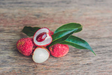 Fresh litchi fruit on an old wooden background.の写真素材