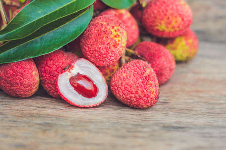 Fresh litchi fruit on an old wooden background.の写真素材