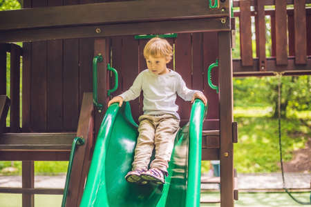Cute little boy is playing on a wooden playground.の写真素材