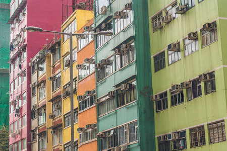 Old houses surrounded modern skyscrapers in Hong Kong. Hong Kong is popular tourist destination of Asia and leading financial centre of the world.の写真素材