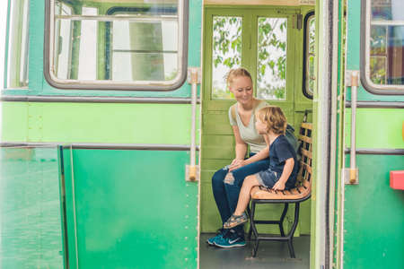 Mom and son are going to go on an old tram. Traveling with children in Hong Kong concept.の写真素材