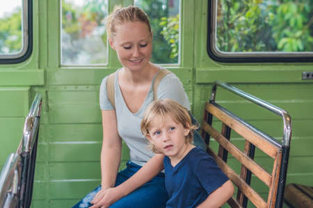 Mom and son are going to go on an old tram. Traveling with children in Hong Kong concept.の写真素材