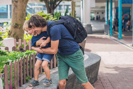 Father and son are walking around Hong Kong. Traveling with children concept.の写真素材