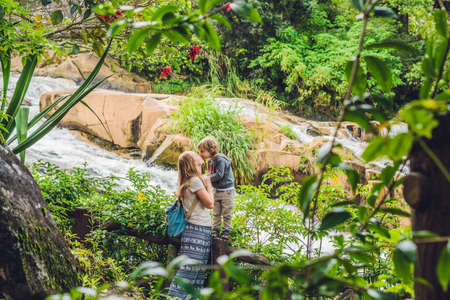 Mother and son on the background of Beautiful Camly waterfall In Da Lat city,の写真素材