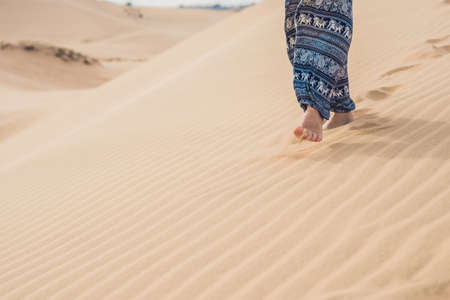 Feet of a woman in the desert.の写真素材