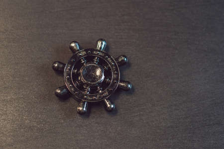 Famous fidget spinner stress relieving n a black wooden background.の写真素材