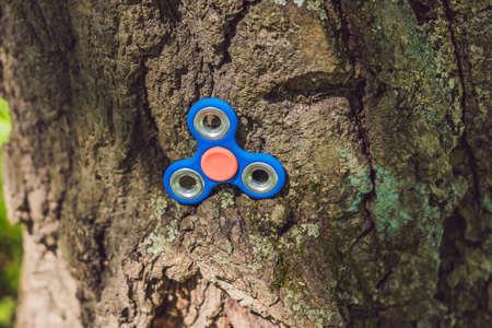 Finger spinner on the playground. Blurred background.の写真素材