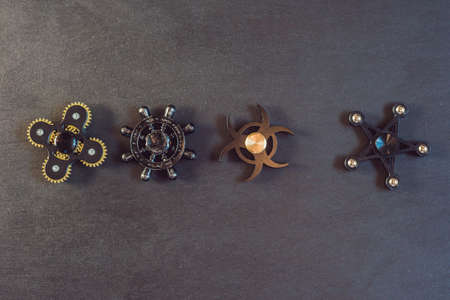 Famous fidget spinner stress relieving n a black wooden background.の写真素材