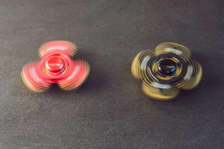 Famous fidget spinner stress relieving n a black wooden background.の写真素材