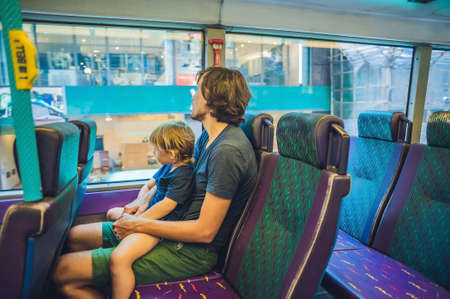 father and son in a public transport Hong Kongの写真素材