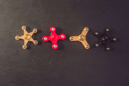 Famous fidget spinner stress relieving n a black wooden background.