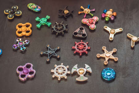 A lot of different spinners on a black background.の写真素材