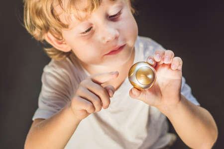 Young boy play with fidget spinner stress relieving toy.の写真素材