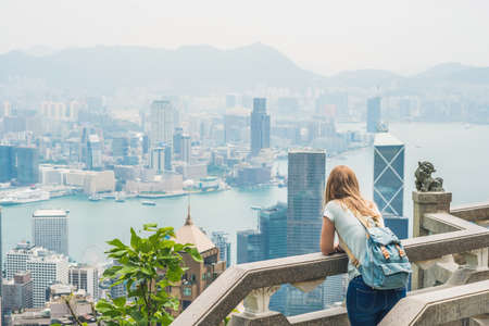 Young woman traveler at the peak of Victoria against the backdrop of Hong Kong.の写真素材