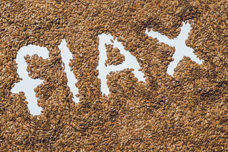 flax word made from flax seeds on white artist canvas.の写真素材