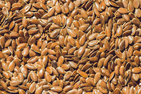 Brown flax seed background. Flax seed is a good source of omega-3 fatty acids, can aid in digestion,...