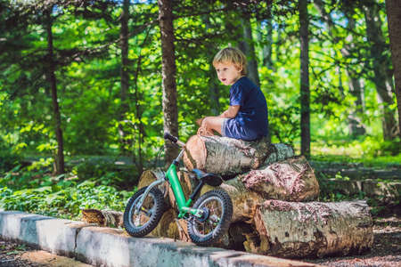 Little boy and his bicycle. Preschool child's first day on the bike. The joy of movement.の写真素材