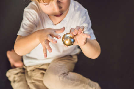 Young boy play with fidget spinner stress relieving toy.の写真素材