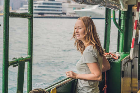 Young woman on a ferry in Hong Kong.の写真素材