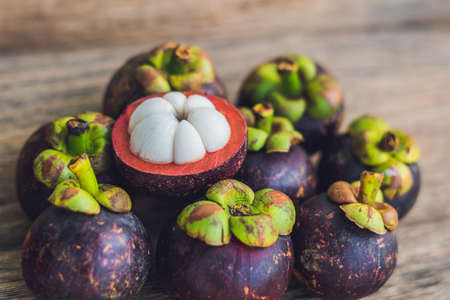 Mangosteen fruit on old wooden table. Tropical Fruits.の写真素材