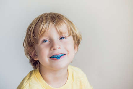 Three-year old boy shows myofunctional trainer to illuminate mouth breathing habit.の写真素材