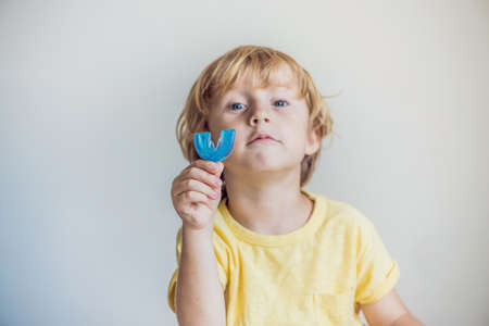 Three-year old boy shows myofunctional trainer to illuminate mouth breathing habit. Helps equalize the growing teeth and correct bite. Corrects the position of the tongue.の写真素材
