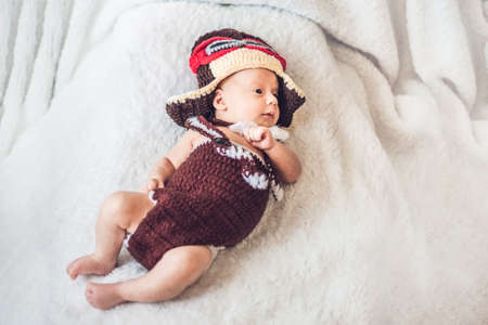cute smiling baby in the cap of the pilot is flying on a white background.の写真素材