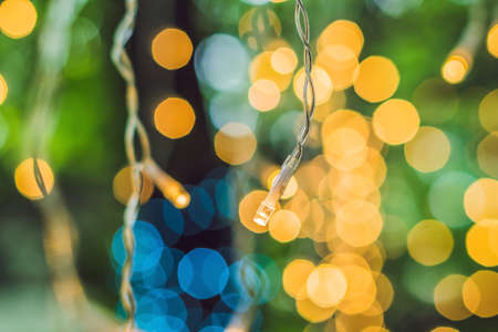 LED lights garland, colorful light bulbs on a bokeh background.