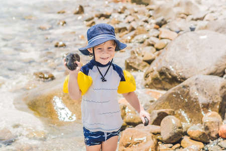 The boy enjoys the tropical sea and the beach.