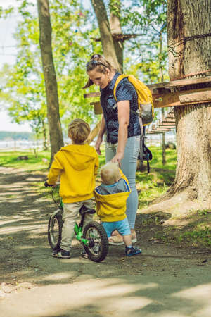 Two happy brothers in yellow sweatshirts in the autumn park.の写真素材