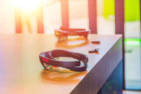 Virtual reality glasses and headphones on the table.の写真素材