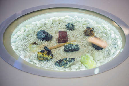 Hammer and different types of minerals on a white background.の写真素材