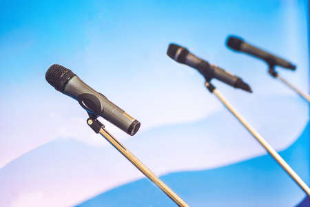 Microphone voice speaker with audiences or students in seminar classroom, lecture hall or conference meeting in educational business event for host, teacher, or coaching mentor.の写真素材