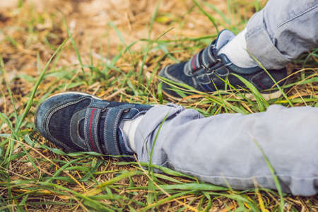 Foot of a traveler boy on a natural background.の写真素材