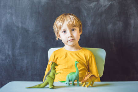 Boy showing a dinosaur as a paleontologist.の写真素材