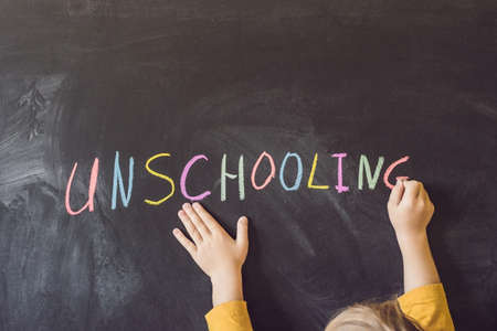 Concept Unschooling Home Learning Back To School Color Chalk on Black Blackboard Background in Row...