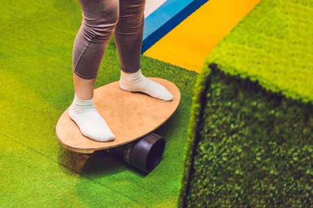 Women on Deck for balance board. Rocker-roller boards. oval wooden deck for balance board. roller for balance board. Rocker-roller boards.の写真素材
