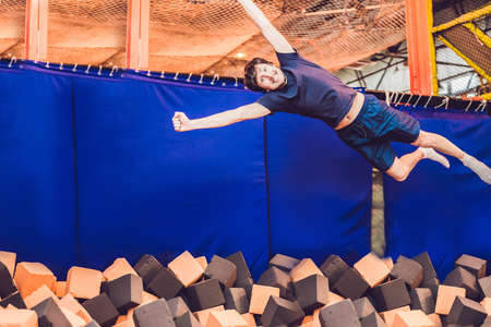 The man jumps into the foam pit.