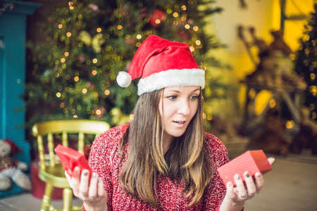 A young woman enjoys her Christmas present. Christmas sale.の写真素材