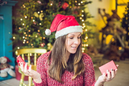 A young woman enjoys her Christmas present. Christmas sale.の写真素材