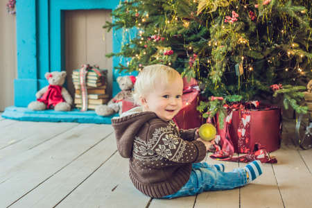 Beautiful little baby celebrates Christmas. New Year's holidays. Baby in a Christmas costume.の写真素材