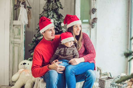 Happy family celebrates Christmas. Mom, Dad and Son in Christmas Decorations.の写真素材