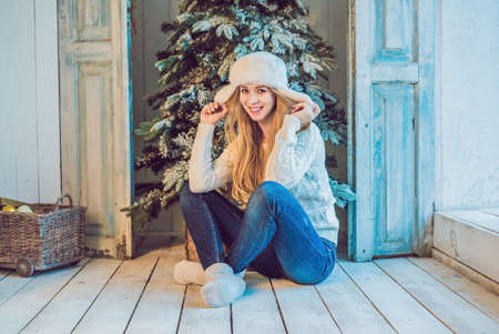 Holidays, celebration and people concept - young woman over christmas interior background. Image with grain.の写真素材