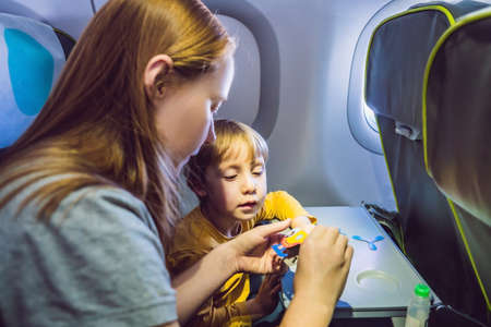Family playing with a board game on a flight.の写真素材