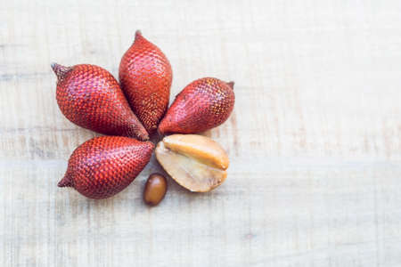 Thailand fruit, Red Fruit Salacca, salak on wooden table.の写真素材