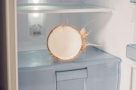 Coconut in the fridge. The Benefits of Coconut Water Concept.