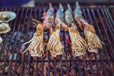 Grilled fresh seafood, food background Barbecue Cooking BBQ seafood on fire.の写真素材