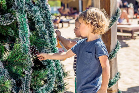 Two boys are celebrating Christmas on the beach.の写真素材
