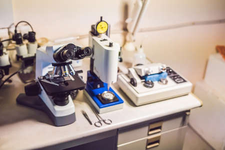 A sample preparation table in aelecron microscopy laboratory with an optical microscope, ultrasonic cutter system and precision micrometer grinder polishing machineの写真素材